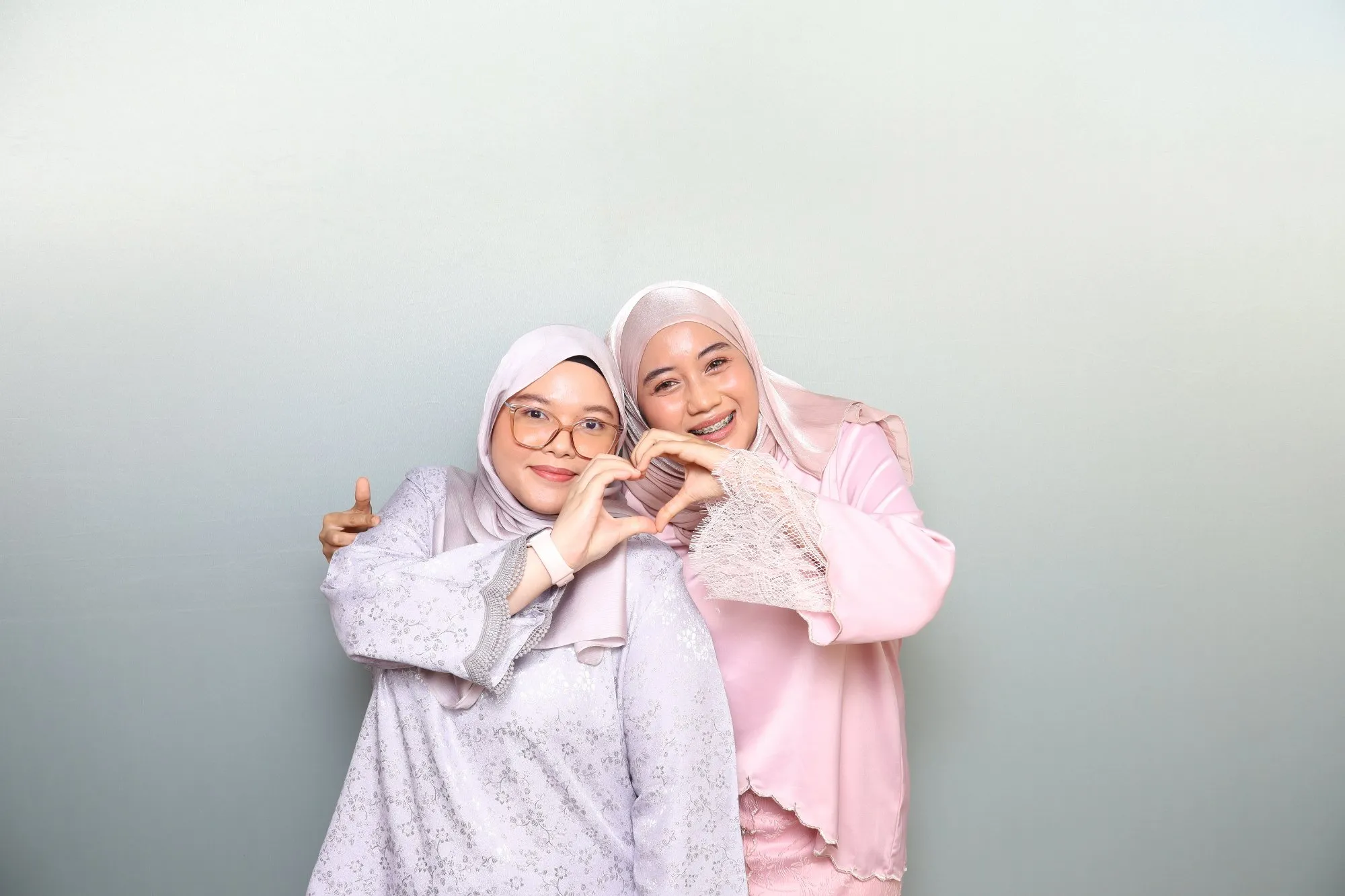 Aksi tetamu di depan backdrop photobooth pada majlis perkahwinan Arina & Iman di Rumah Abang Jamil, Balok